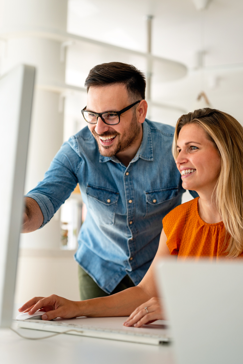 Happy couple doing business together working at small office